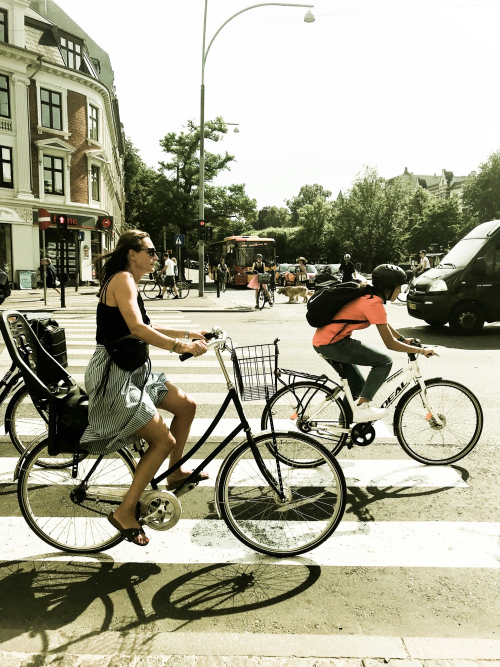 Cyclists with a child seat waiting at a Copenhagen crosswalk